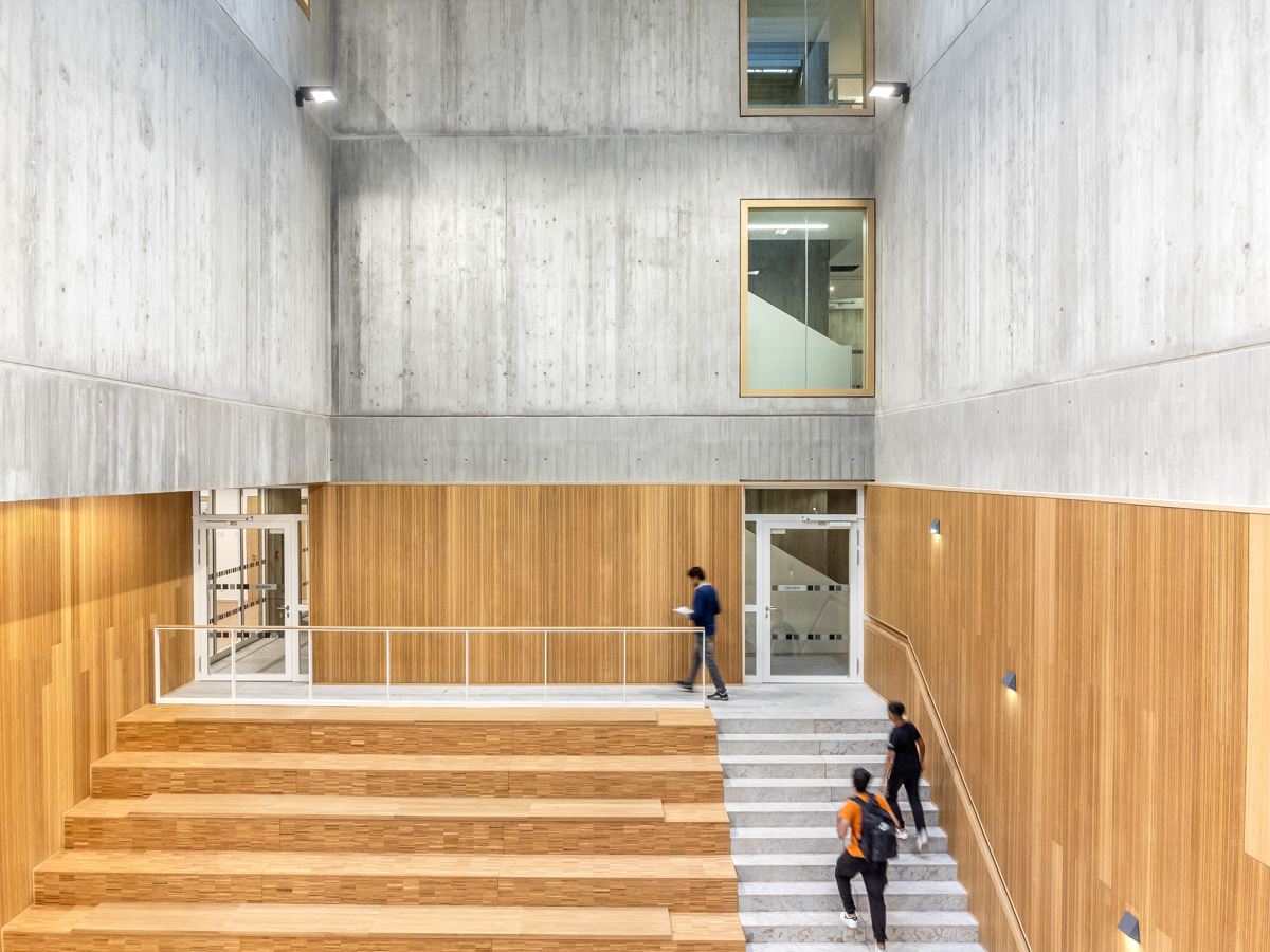 Detail der Sitztreppe der Aula auf der einige Schüler hinaufgehen